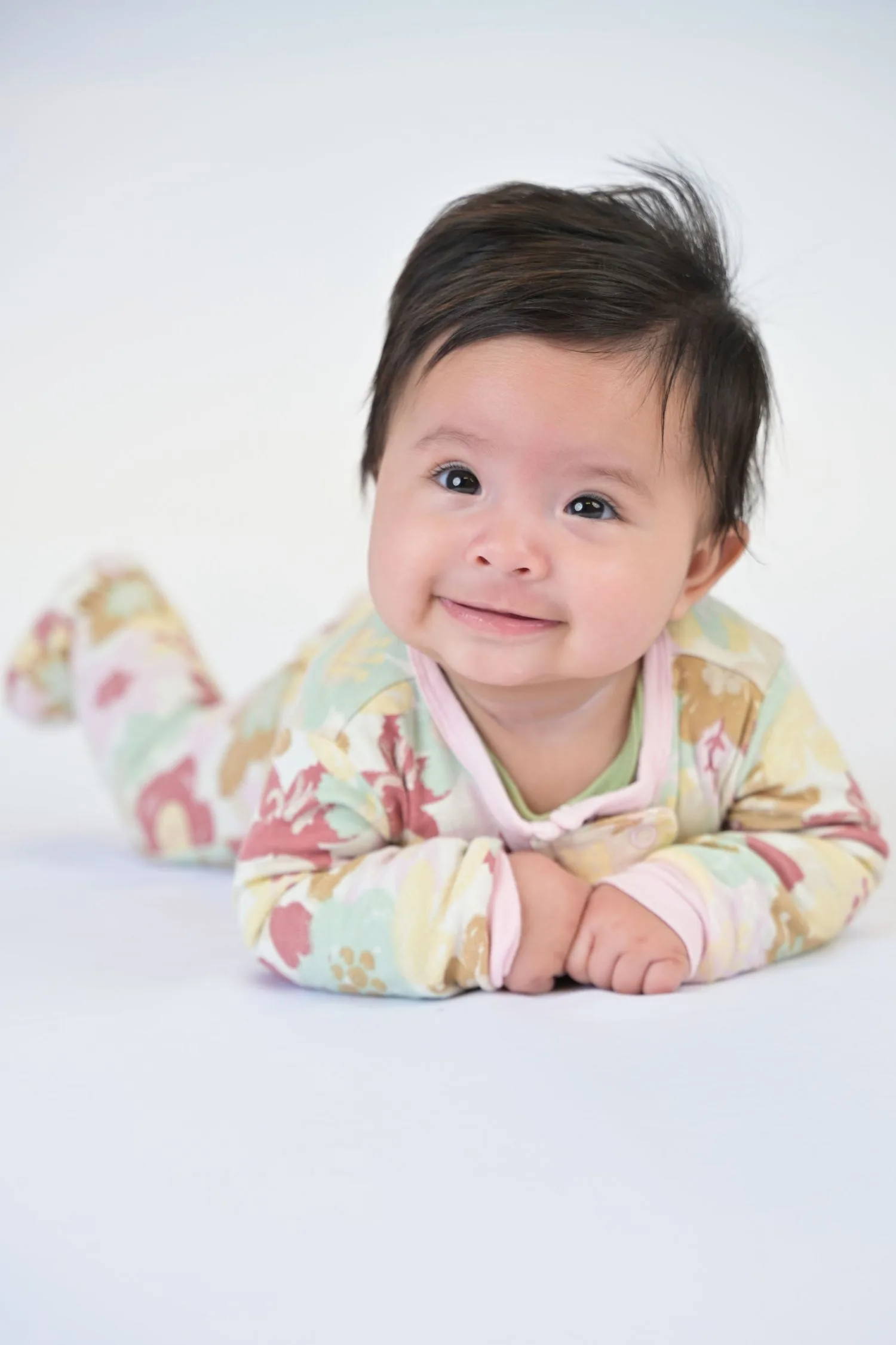 Young child photographed against a clean white studio background