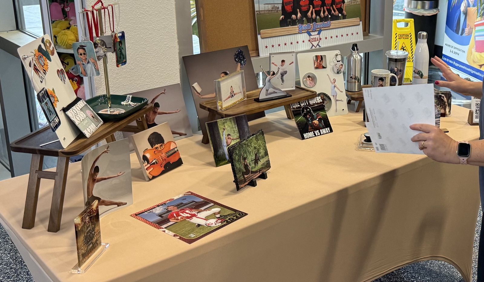 Picture day product display table with prints, composites, and sample products