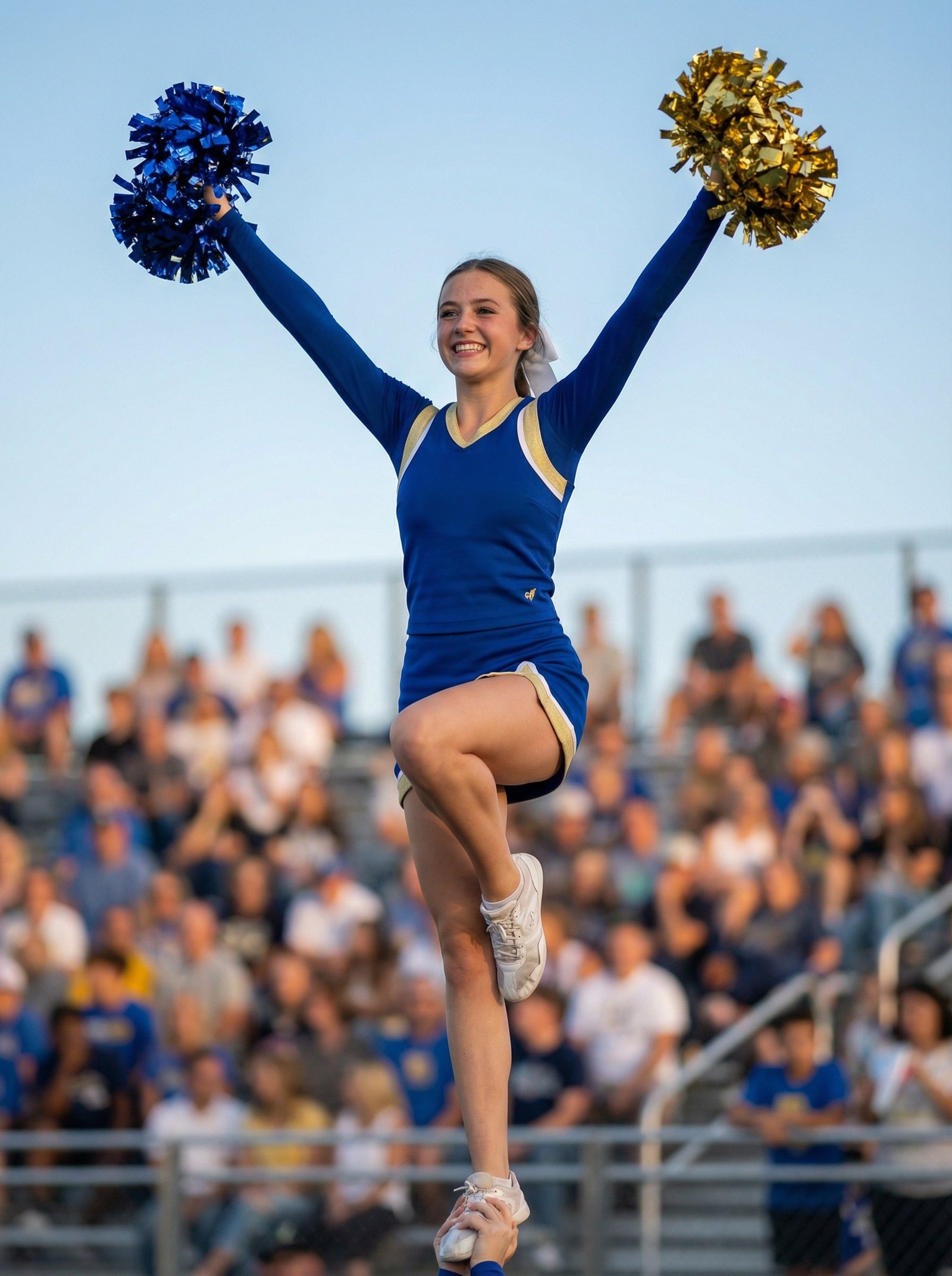 Cheerleaders mid-stunt pyramid formation