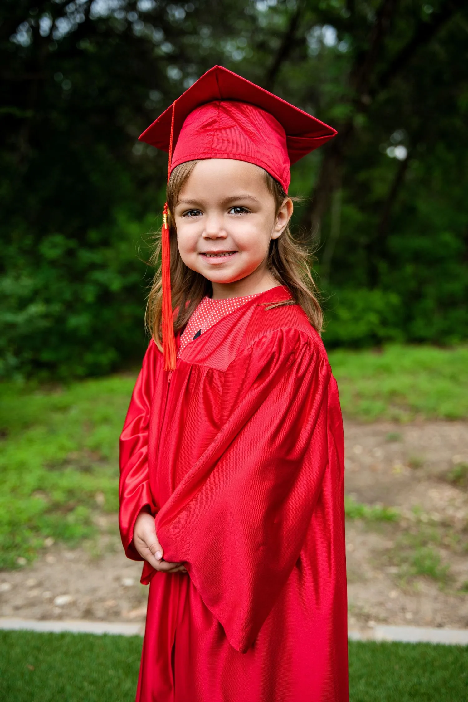 Pre-K graduate in cap and gown portrait 3