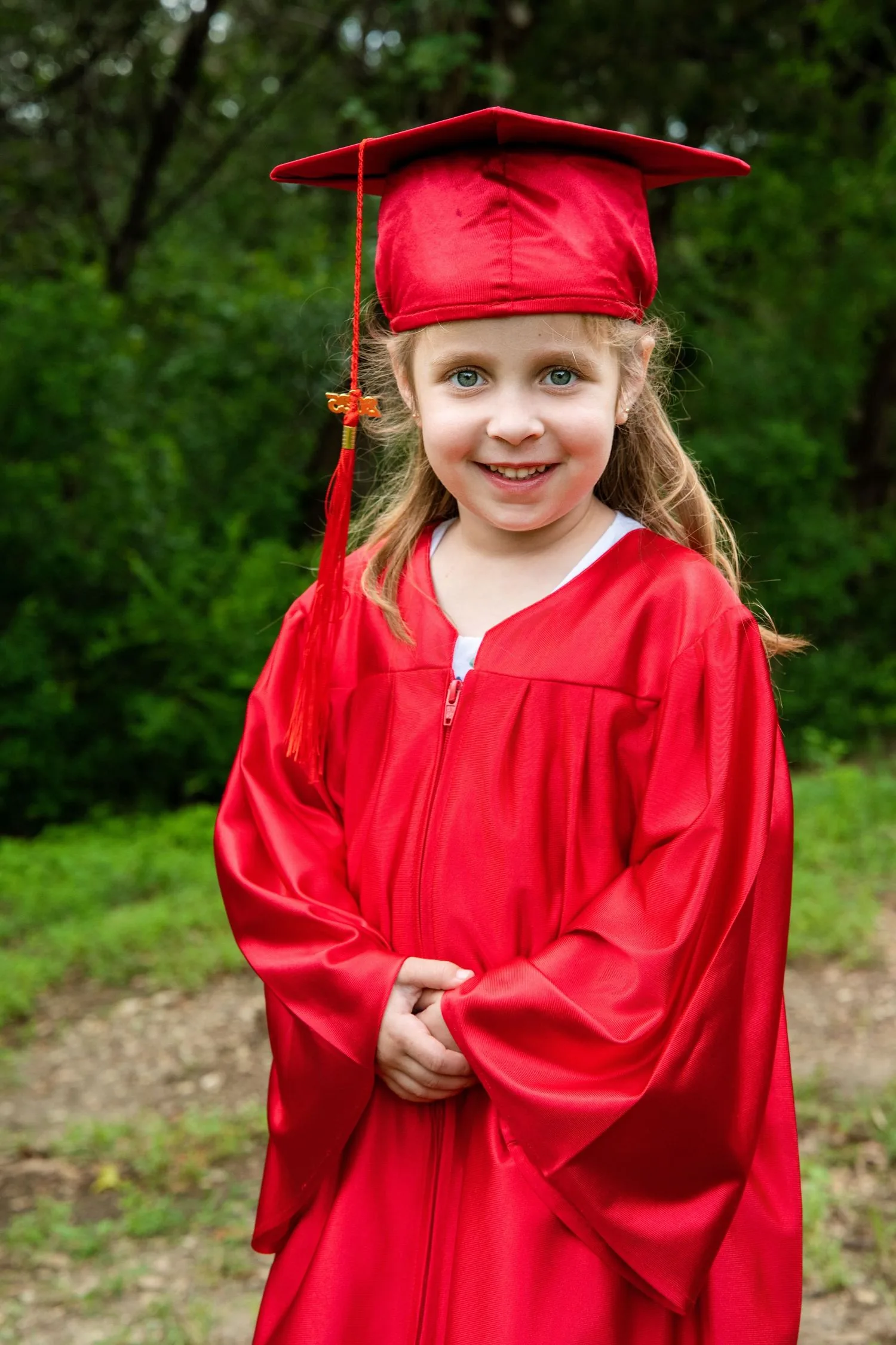 Pre-K graduate in cap and gown portrait 7