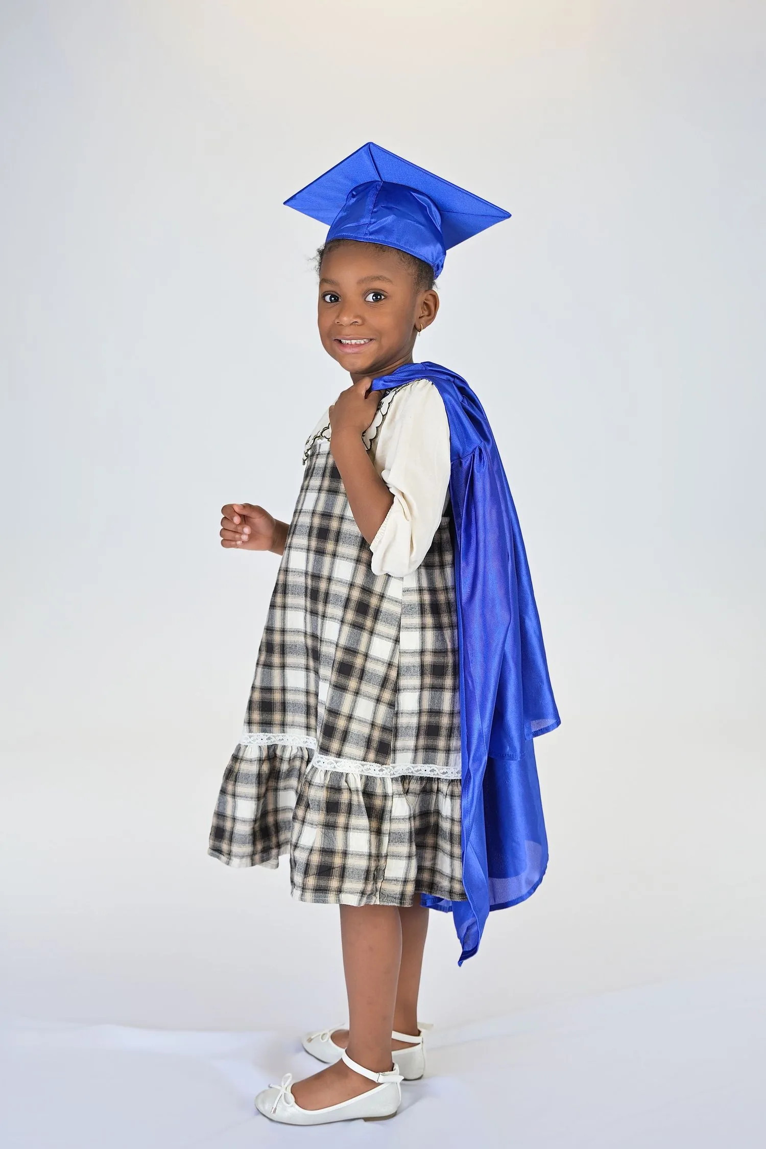 Pre-K graduate in cap and gown portrait 2