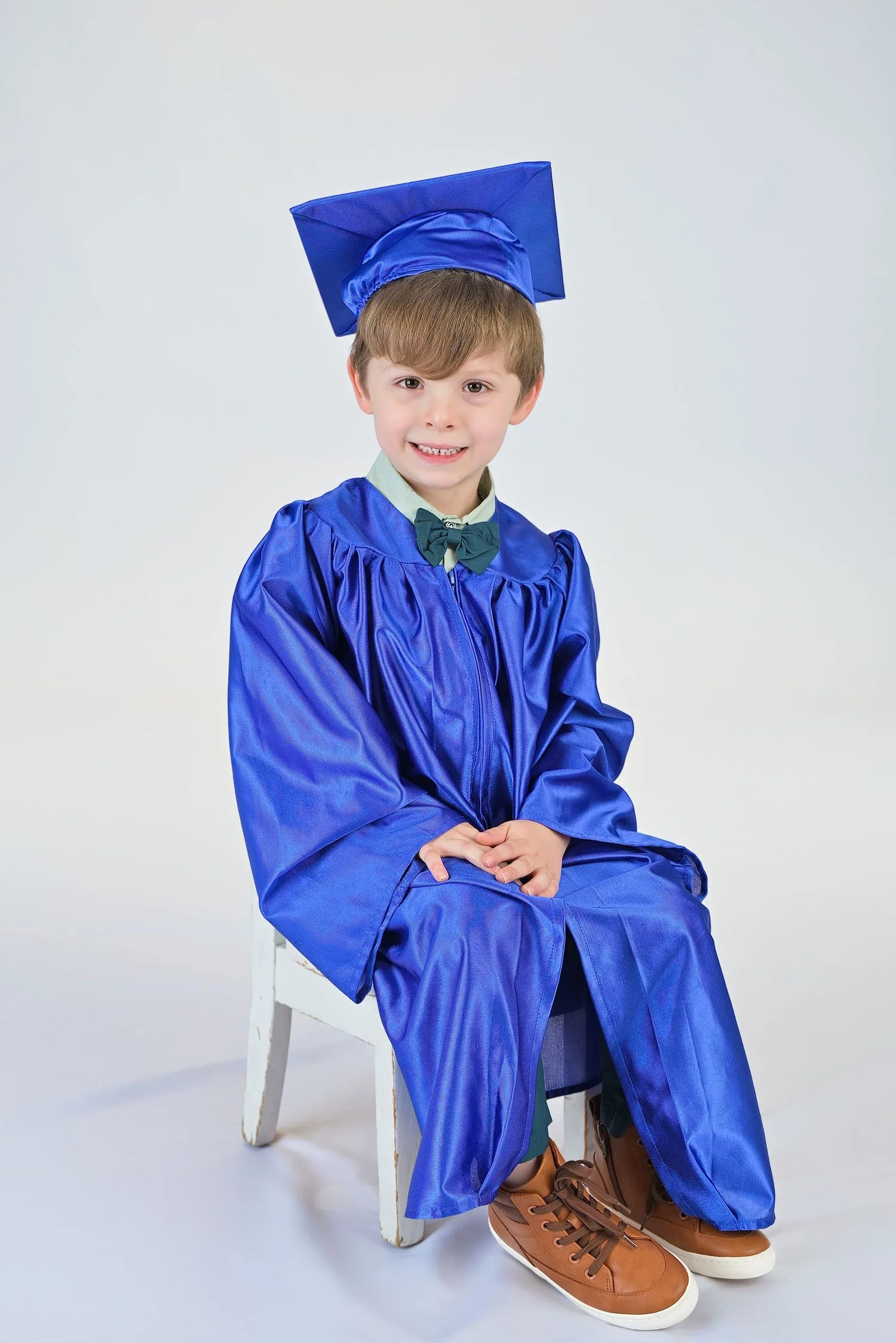 Pre-K graduate in cap and gown portrait 4