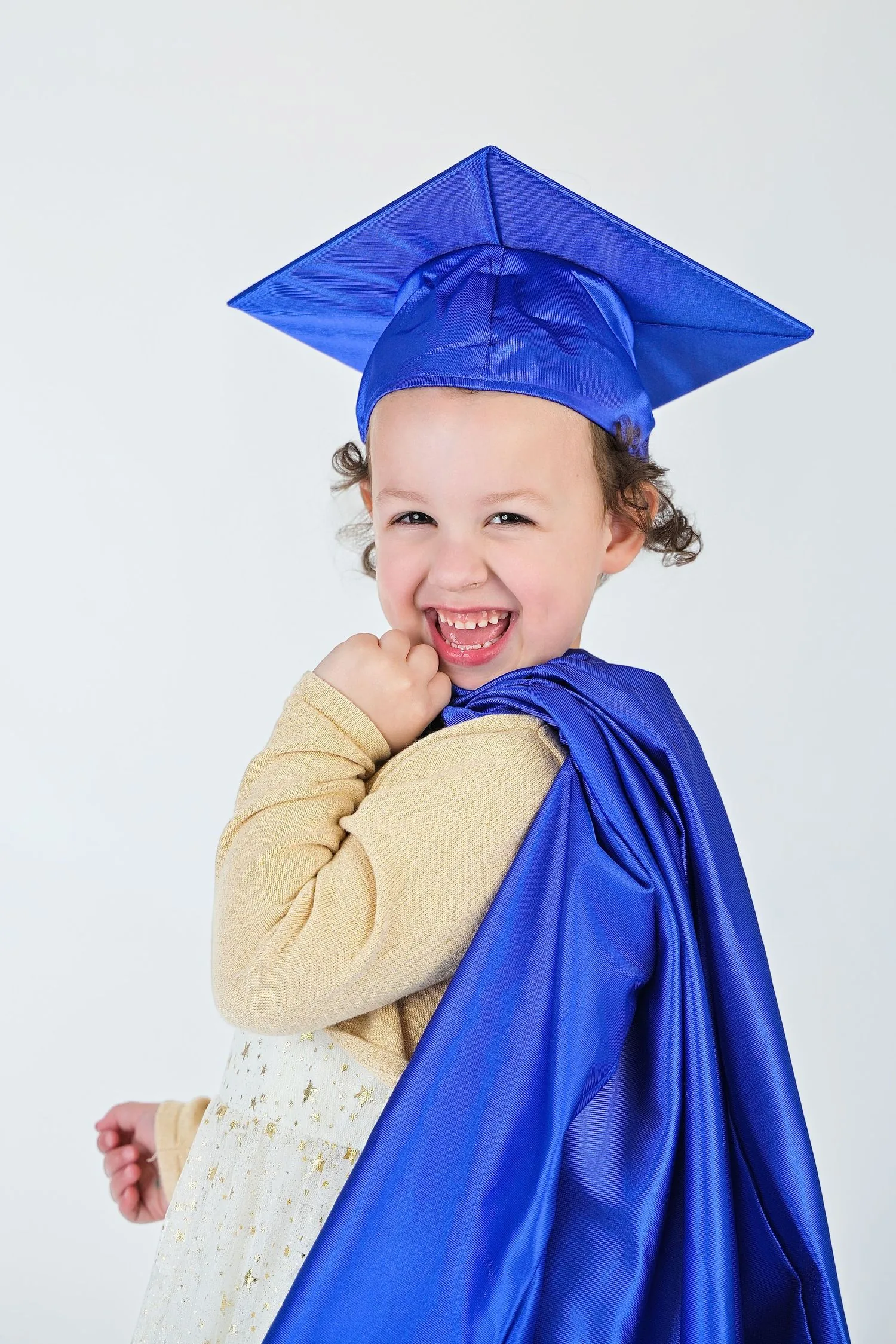Pre-K graduate in cap and gown portrait 6