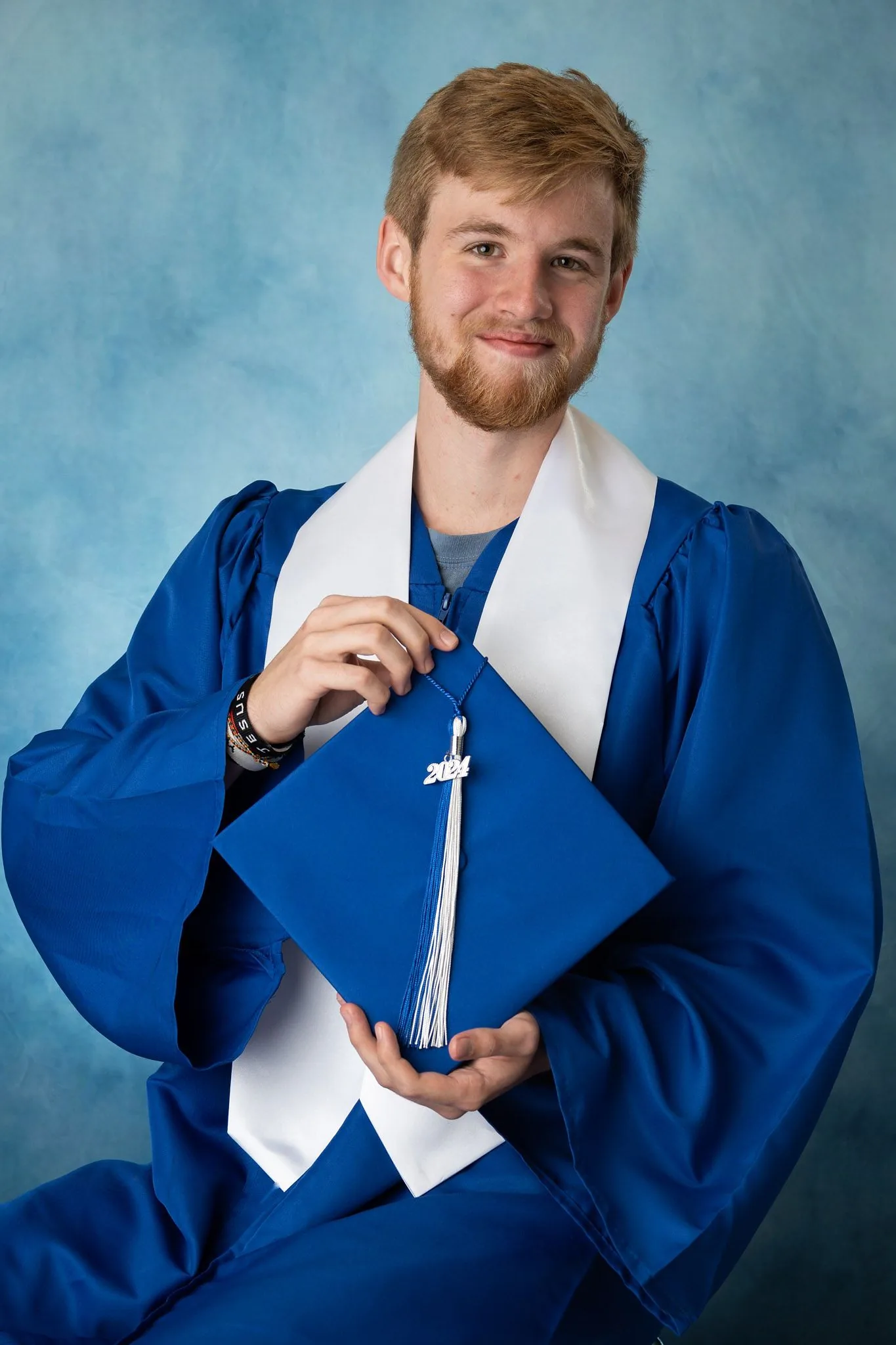 Graduating high school senior in cap and gown