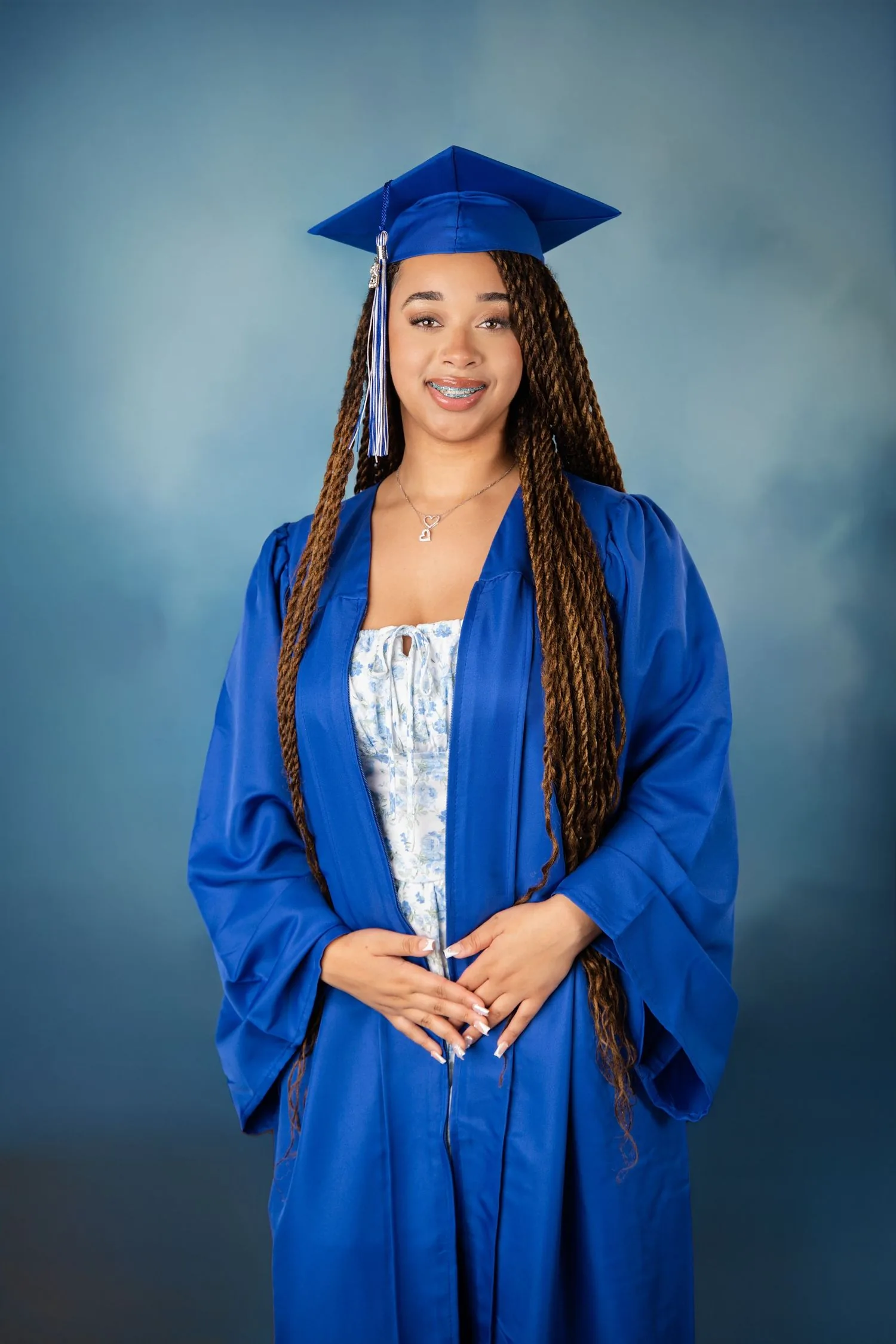 High school senior wearing a graduation cap and gown